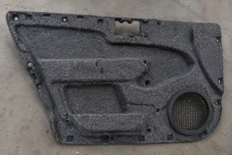 Automotive door trim panel with felt insulation backing